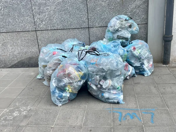 8 Valorlux sacs bleus on the pavement, in Luxembourg.
