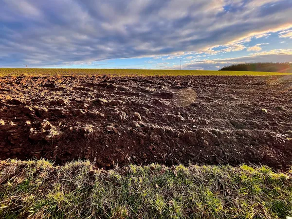 A ploughed field with cloudy sky, in Luxembourg.